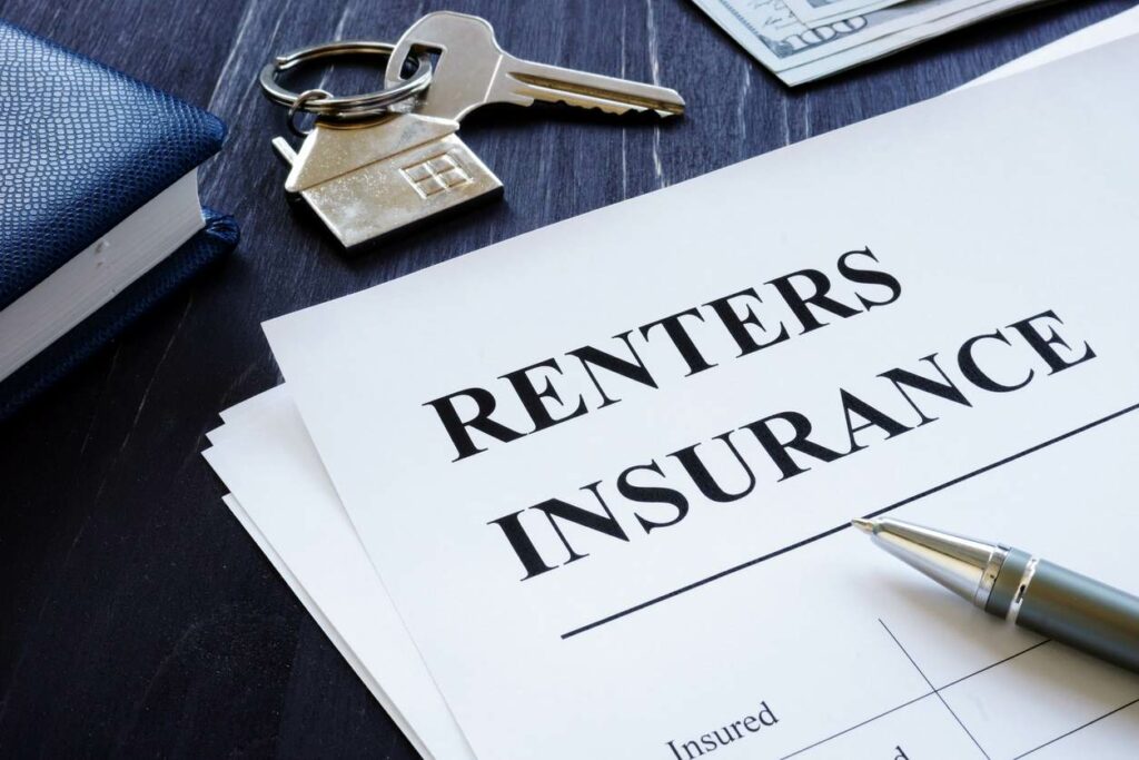 A document that reads "renters insurance," underneath a pen and a pair of keys