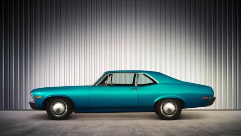 A vintage teal car in storage