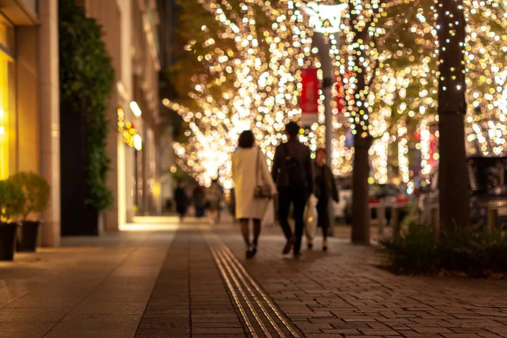 Couple walking together while viewing holiday lights in town.