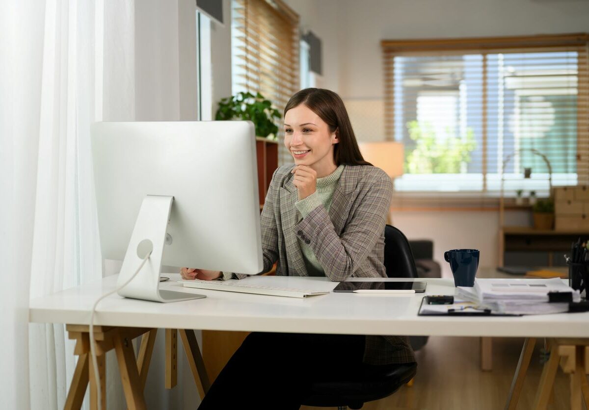 A young businessperson working at a home office.