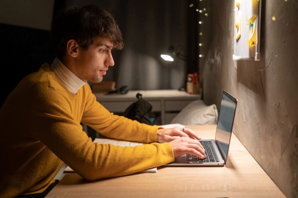 College student studying at his desk. 