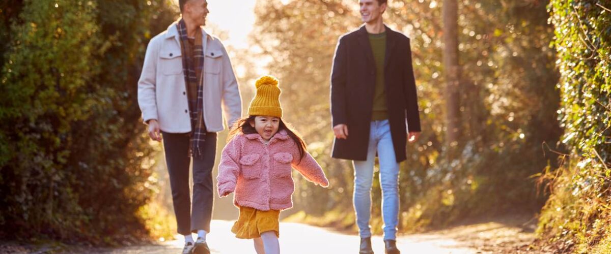 A happy family going on a walk in the fall.