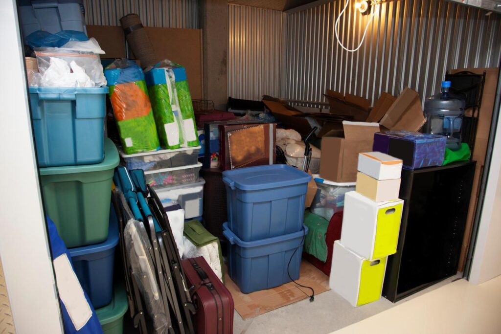 A fully packed storage unit with boxes and containers. 